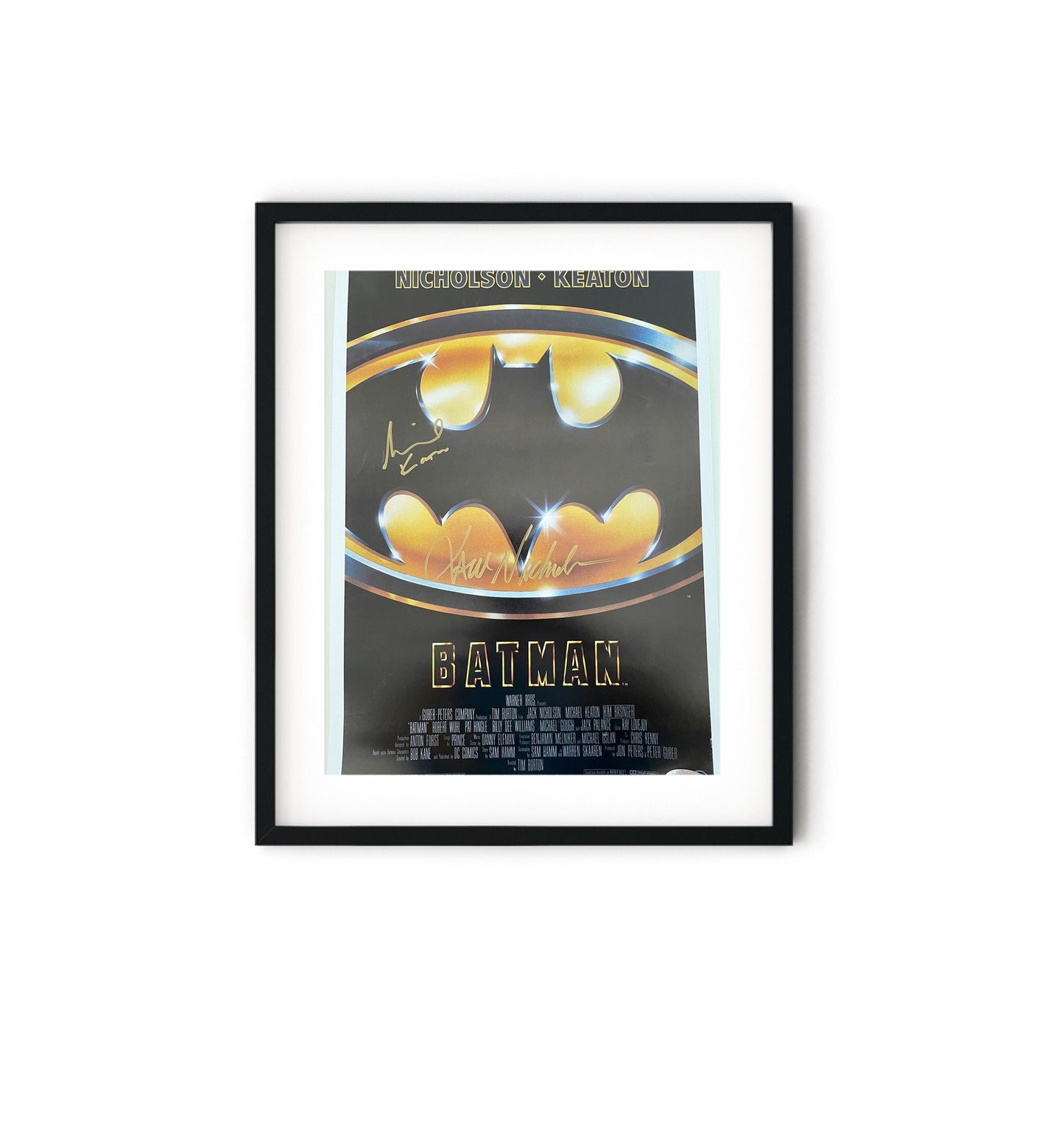 a batman movie poster hanging on a wall