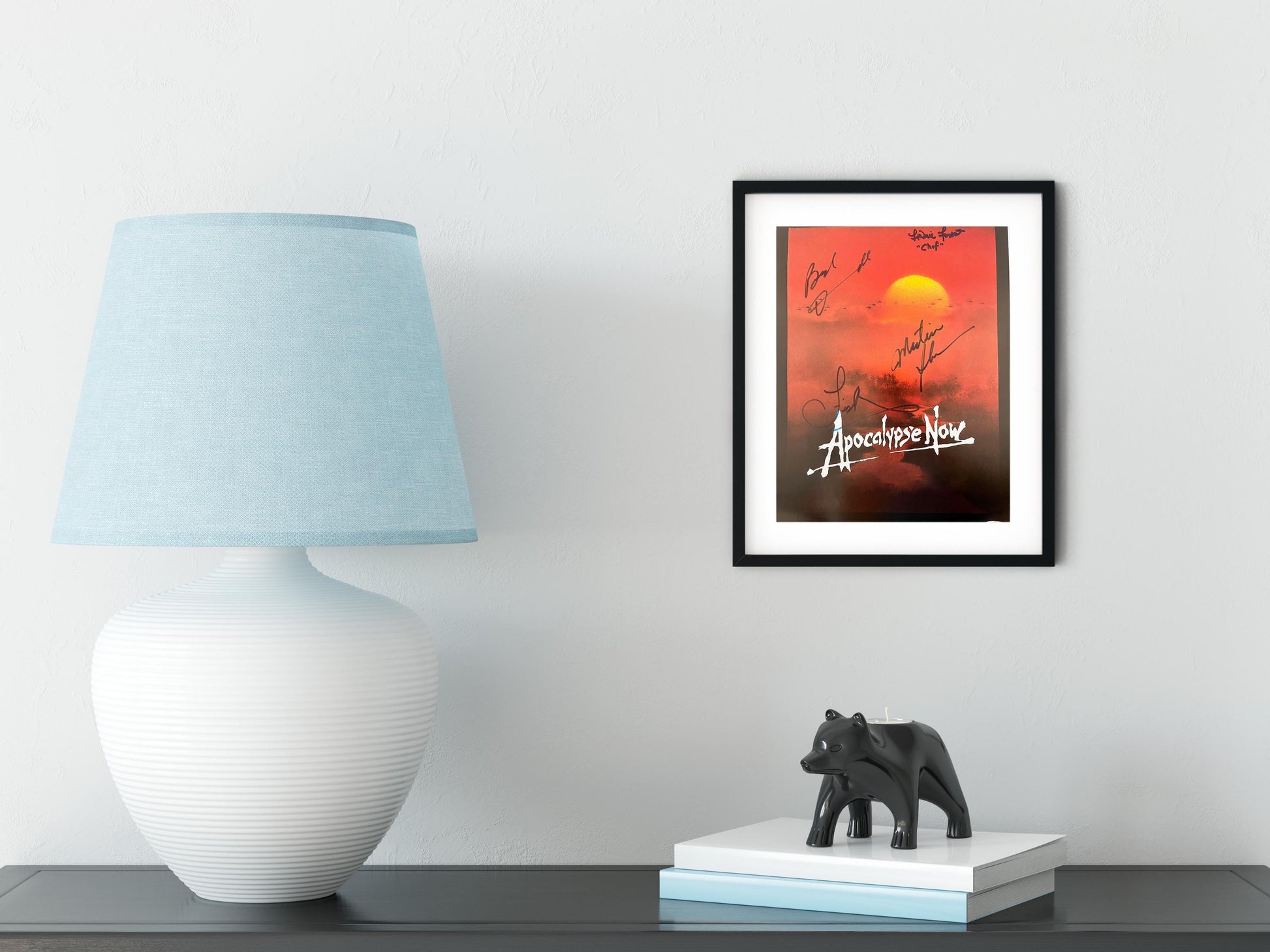 a picture of an elephant on a table next to a lamp